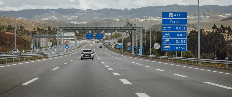 A41 with an electronic toll gantry and a toll charges sign by class