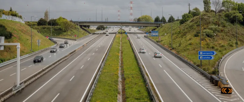 Motorway with a grassed central reservation and an overpass