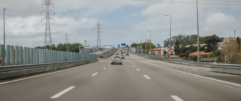Motorway with noise barriers and high-voltage power lines